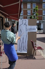 France, Seine Maritime, Le Havre, Downtown rebuilt by Auguste Perret listed as World Heritage by UNESCO, an artist creates a portrait for an exhibition at a cafe terrace in the fishermen's district