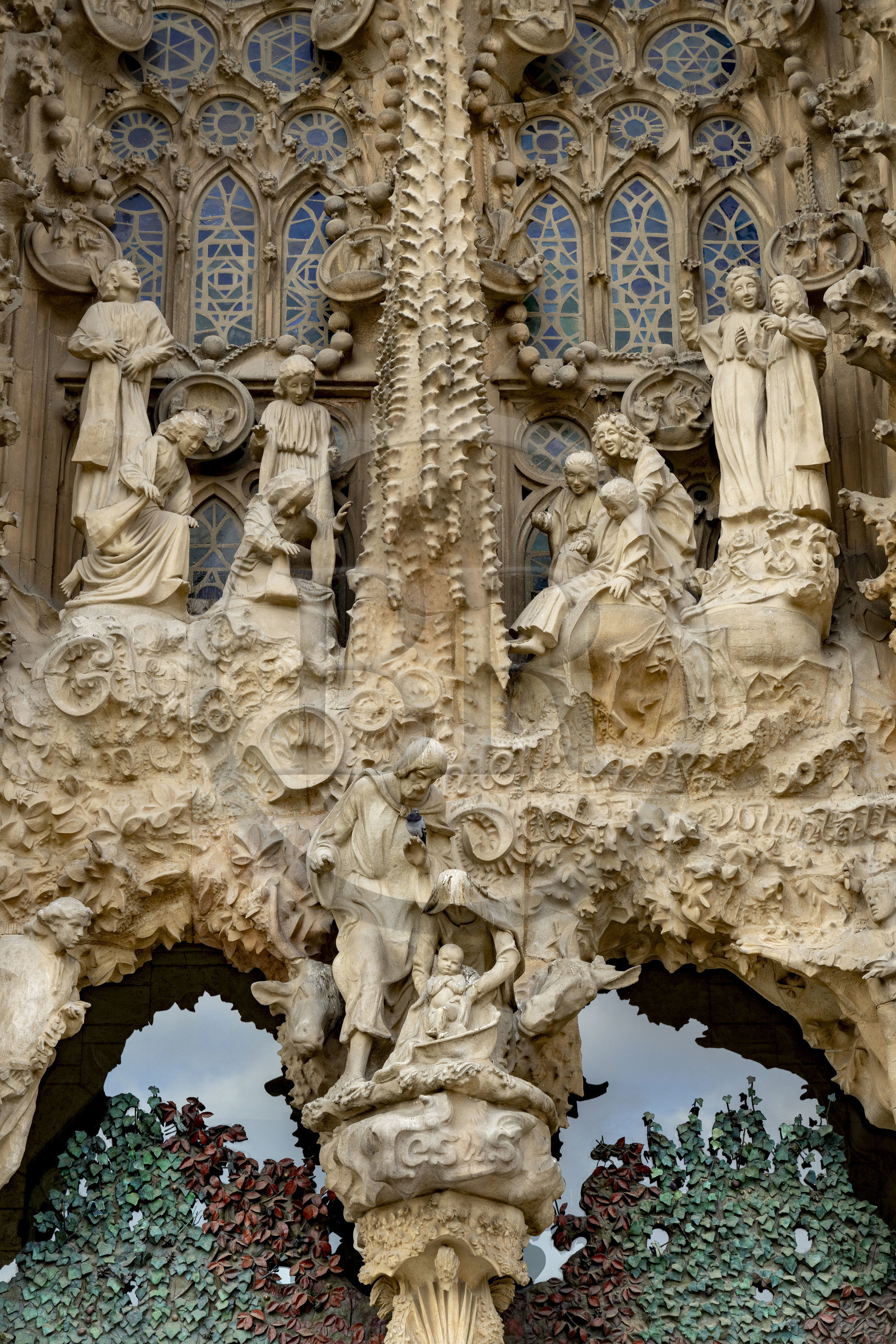 Spain, Catalonia, Barcelona, Eixample district, Sagrada Familia basilica by Catalan modernist architect Antoni Gaudi, listed as a UNESCO World Heritage Site, facade of the Nativity, the Charity Gate, the mother of God and Saint Joseph with Jesus just born