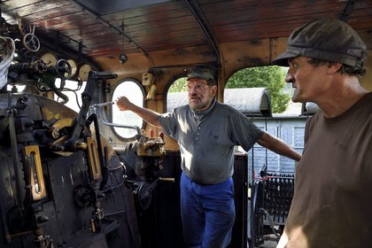France, Alpes-Maritimes, Puget Theniers, steam engine warming up, Daniel Bonneau (engineer and therefore train driver) and Frederic Laugier (fireman or stoker) volunteers of G.E.C.P. that restores and operates the Train des Pignes, the team in the cabin