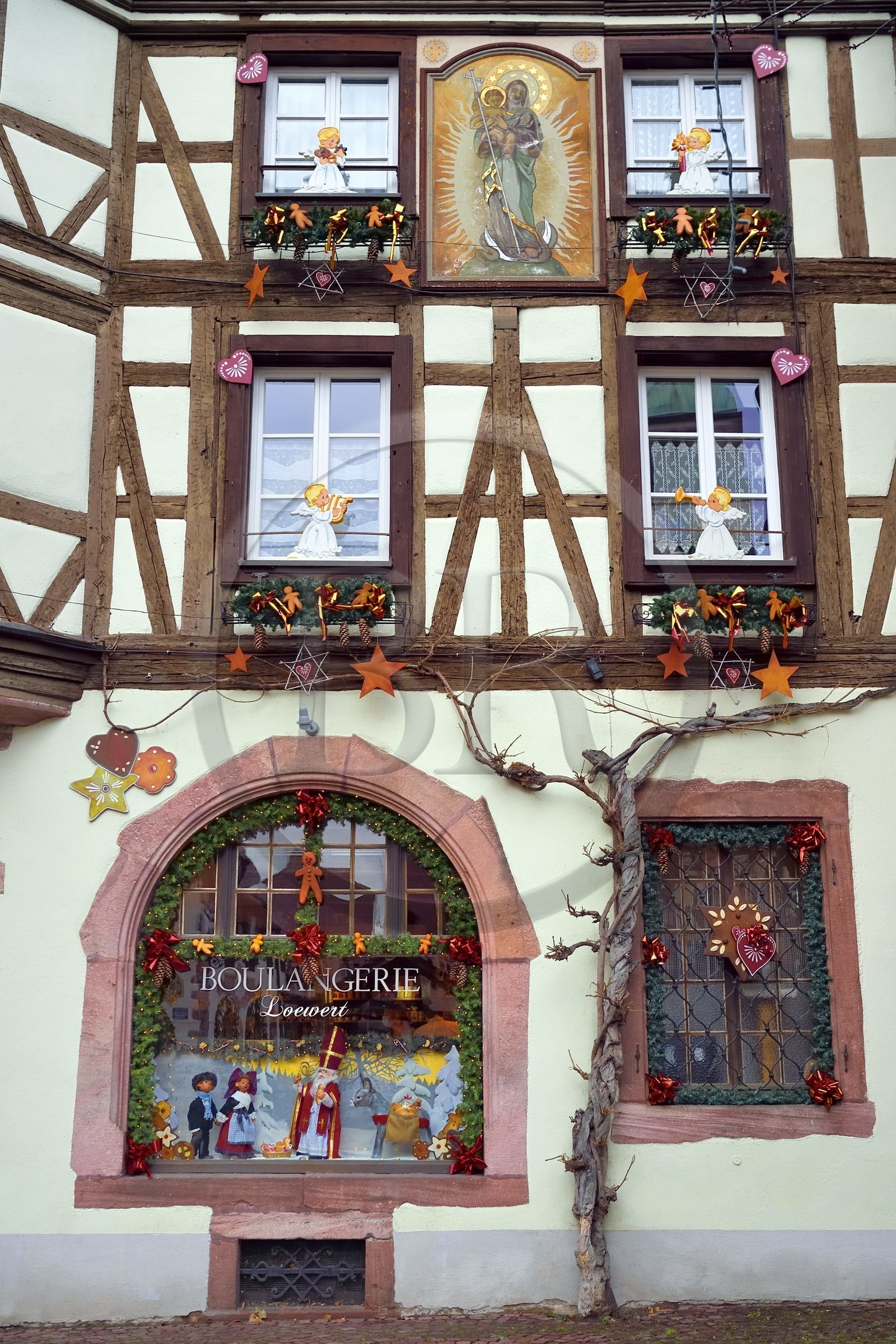 France, Haut Rhin, Strasbourg, Kaysersberg, half-timbered house of the Loewert bakery with a painting of the Virgin and Child on the facade and Christmas decorations