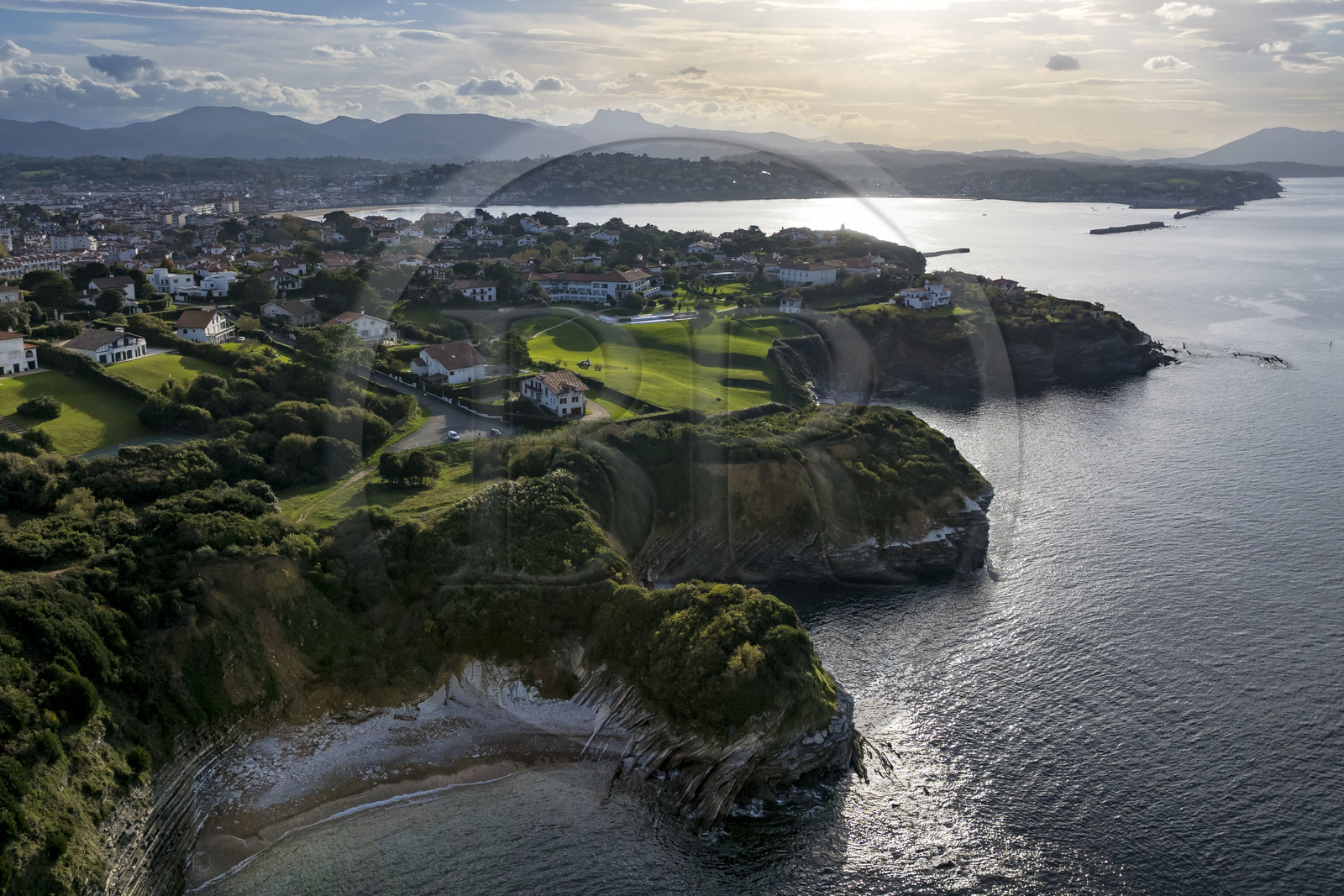 France, Pyrenees Atlantiques, Basque Country coast, Saint-Jean-de-Luz, the coastal path on the GR 8 running along the flysch cliff of the Pile d'Assiettes, a sort of mille-feuille alternating hard rocks and soft rocks, the bay of Saint-Jean-de-Luz in the background (aerial view)