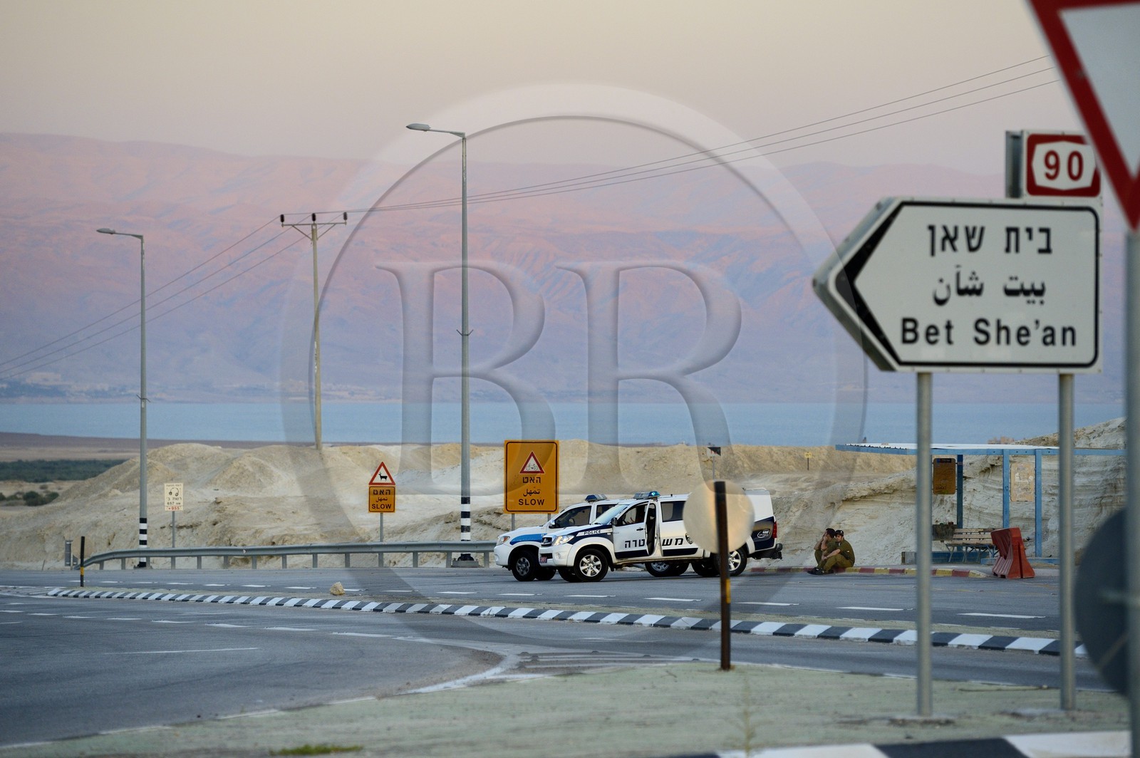 Israel, Beit HaArava junction, police patrol, the Dead Sea and the mountains of Jordan in the background