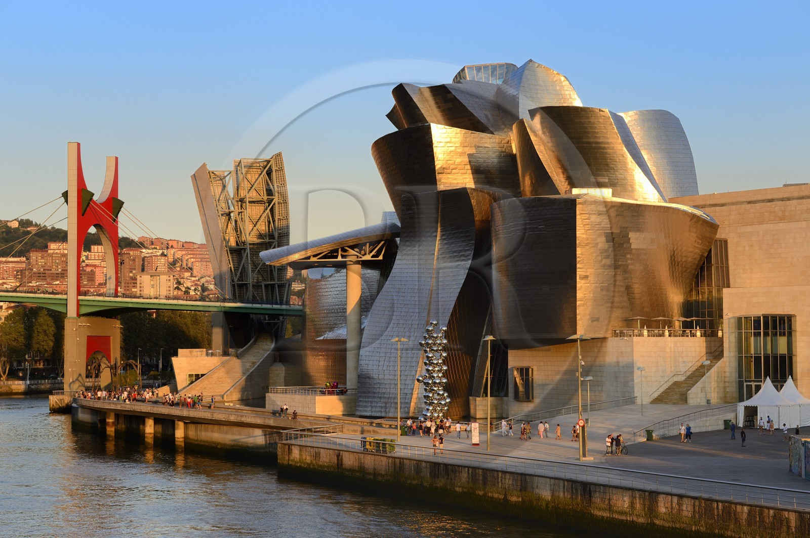 Spain, Basque Country Region, Vizcaya Province, Bilbao, the Guggenheim Museum designed by Frank Gehry and the Salve bridge with Les Arches Rouges artpiece by French artist Daniel Buren in the background